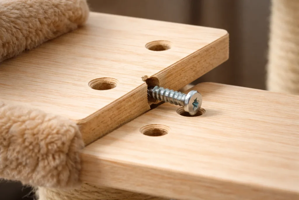 Misaligned screw holes on a cat tree panel causing assembly failure